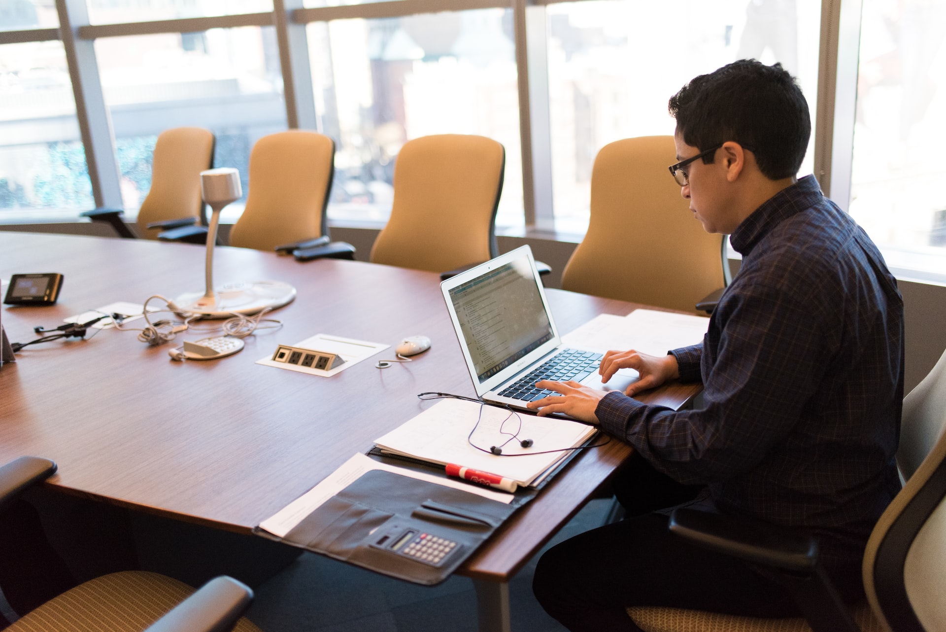 man uses laptop at the conference table